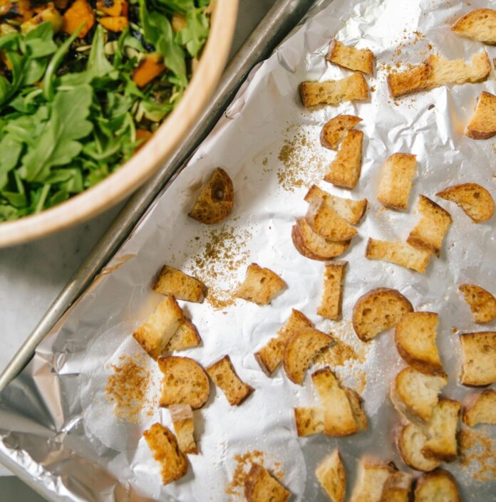 Salad with a pan of fresh croutons