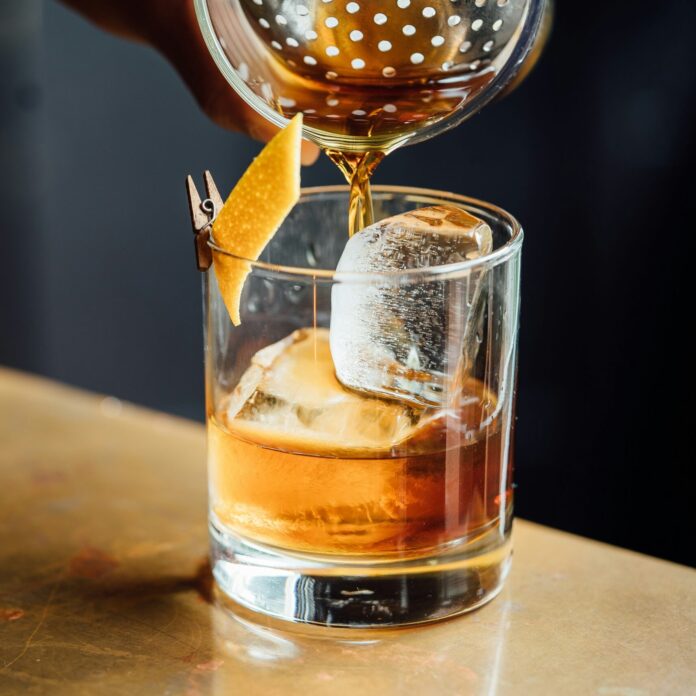 Paper plane cocktail in a rocks glass