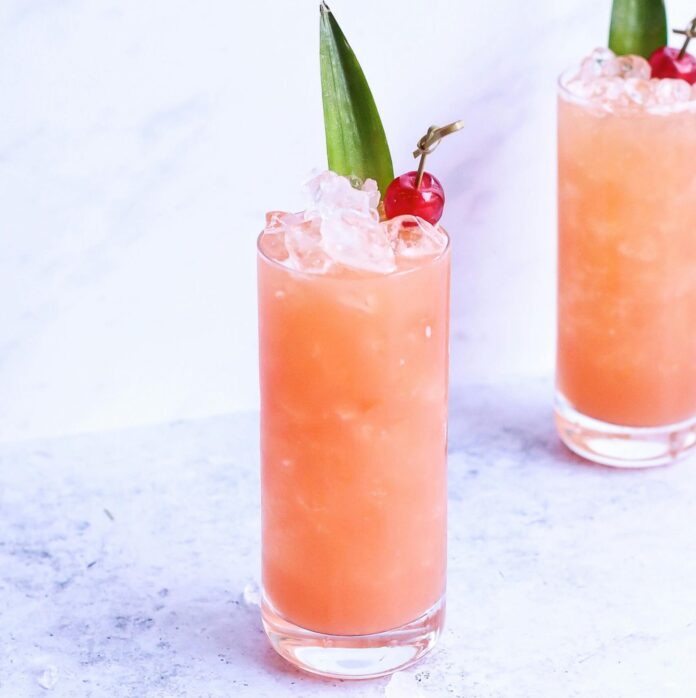 Paloma cocktail with cherry garnish